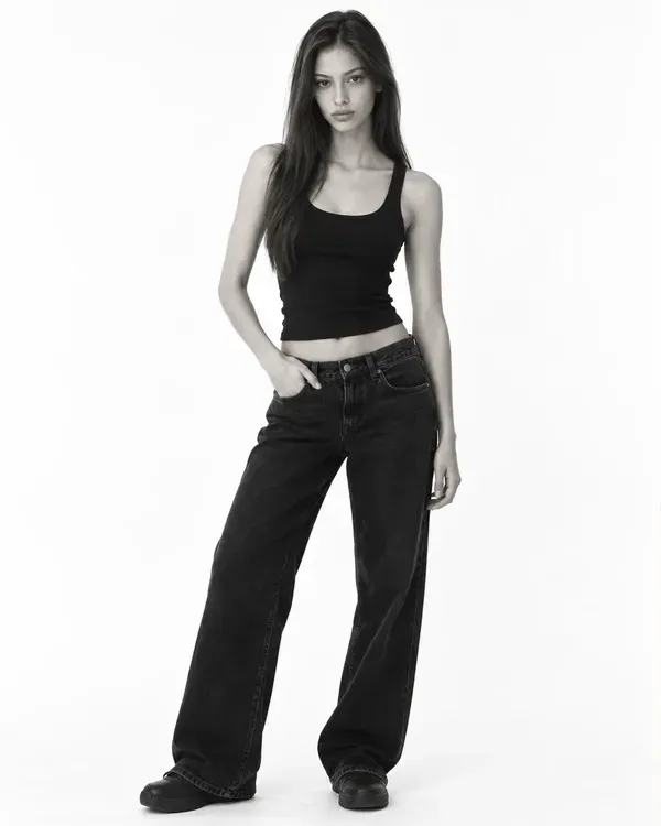 Three black and white photos of a model: a full-length shot, a headshot and a seated pose, the mix of photos a comp card needs
